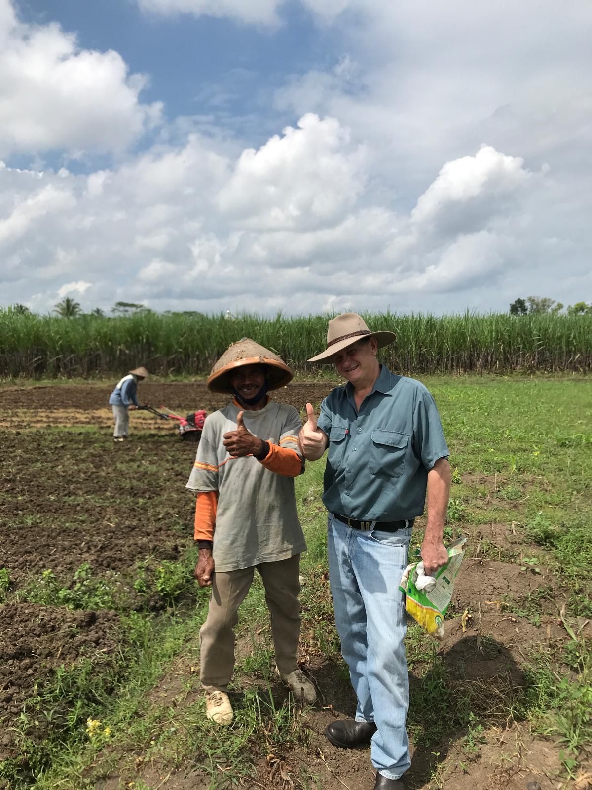 Richard Slaney with a local farmer at a corn growing trial plot in East Java